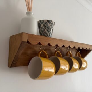 mug shelf with scalloped edge design